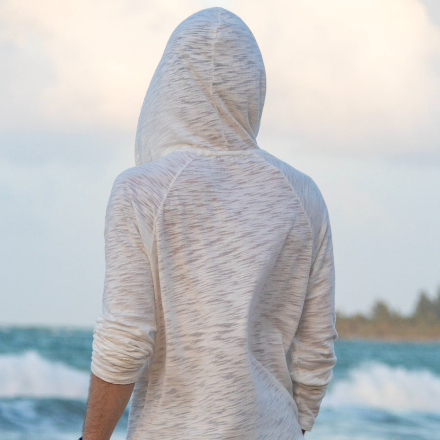 Back of the Pearle BreezeWeight Pullover Hoodie with the hood up, by the ocean