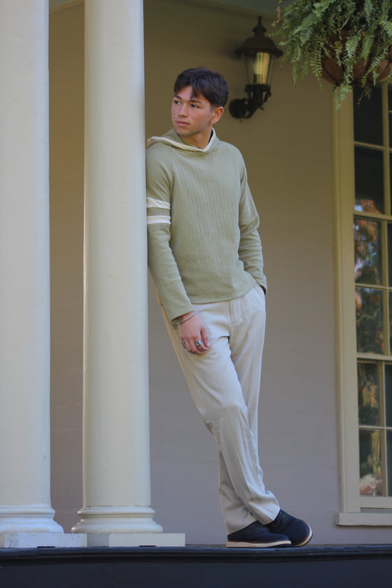 Man in a Sicilian Moss Captain's Pullover Hoodie and chinos on a porch